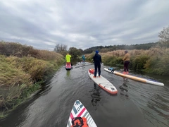 Paddleboarding together on a quiet river